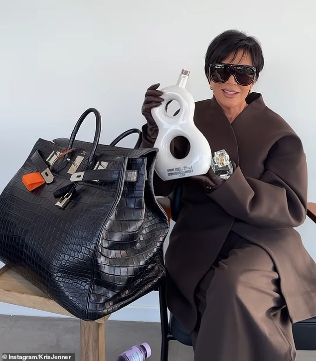 She looked glamorous in an oversized brown coat and matching pants teamed with designer sunglasses and brown gloves while on the set of a photo shoot.