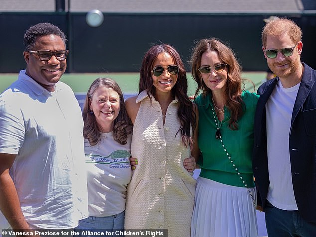 Alex Romain (left), president of the Alliance for Children's Rights, joins Meghan (center), Kelly McKee Zajfen (second right) and Prince Harry (far right) at the September tennis tournament.