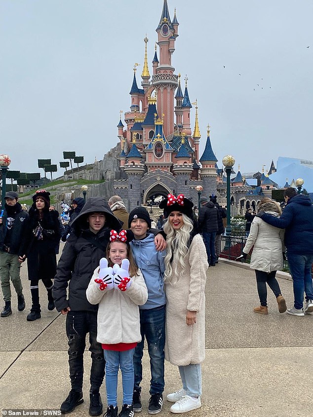 Happier times: Lewis and his three children enjoy a family trip to DisneyLand Paris before he falls ill.