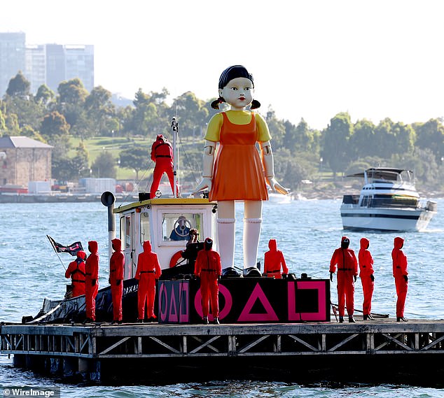 The mysterious convoy made a dramatic entrance into Sydney Harbor as it escorted the series' infamous doll onto a harbor barge.