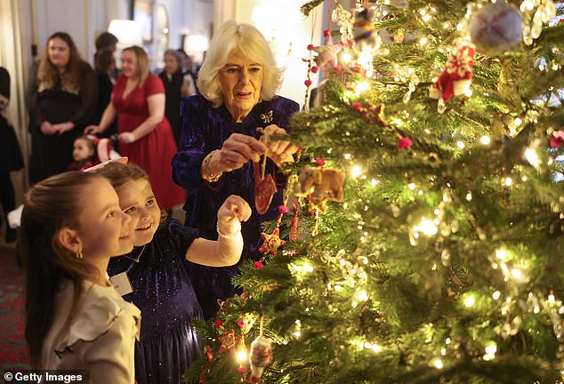 During the event, which has become a long-standing festive tradition, the Queen chatted with children, decorated a Christmas tree and handed out beautifully wrapped gifts.