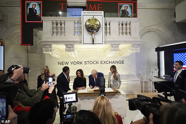 President-elect Donald Trump signs a guestbook after ringing the opening bell