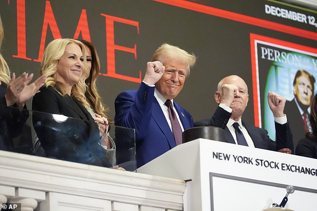 Donald Trump gives his signature raised fist wave at the stock market