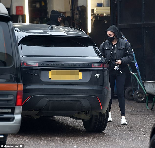 The N-Dubz singer, 36, wrapped up in a black bomber jacket over a hoodie, while adding a pair of athletic leggings and sneakers to her ensemble.