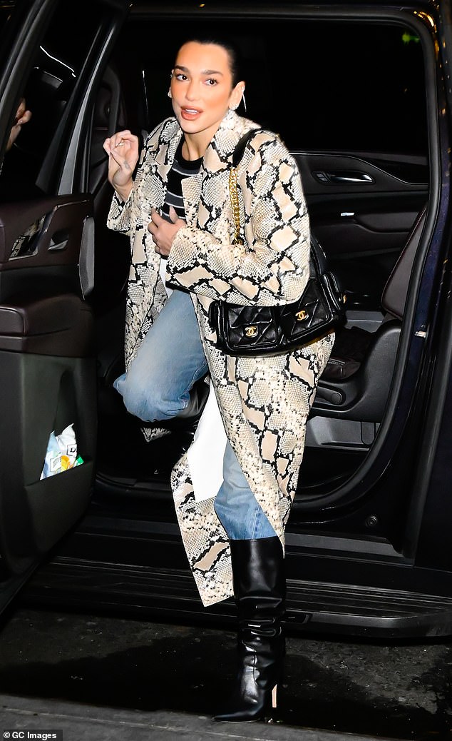 Dua looked effortlessly chic as she arrived in a long snake-print coat, which she paired with relaxed light denim jeans.