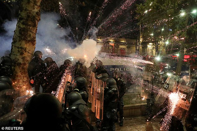 The fierce protests were sparked by the government's decision to suspend negotiations on the country's accession to the European Union. Travis says he was walking home from a bar when police attacked him