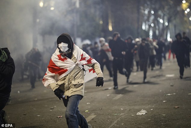 Police use tear gas to disperse Georgian opposition supporters protesting outside the Parliament building in Tbilisi, Georgia, on November 30, 2024.