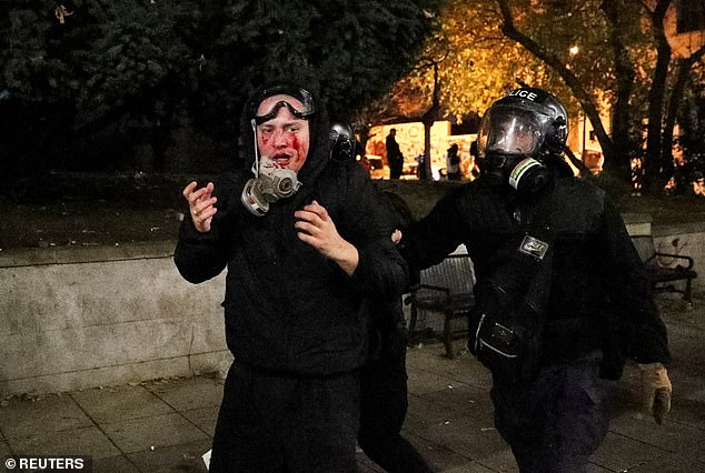 Police officers escort a demonstrator during a demonstration by supporters of opposition parties, protesting against the new government's decision to suspend European Union accession talks and reject budget subsidies until 2028, in Tbilisi, Georgia, on 30 November 2024.