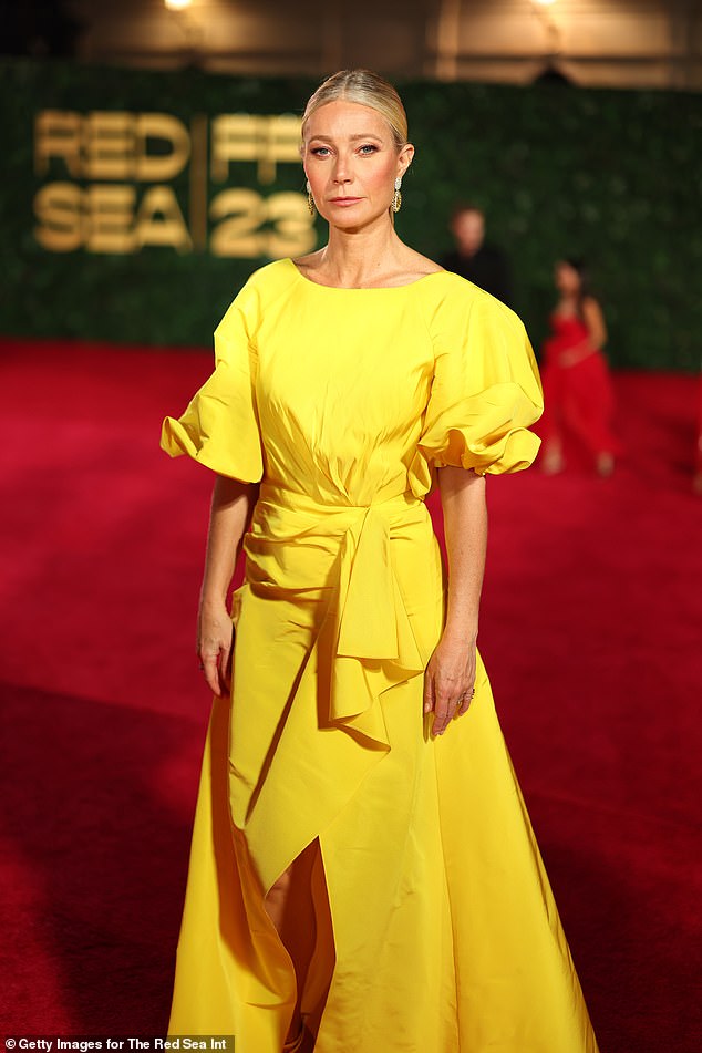 Gwyneth was also dressed to impress as she modeled a canary yellow dress with puffed sleeves, a tie waist, and a slit in the front.