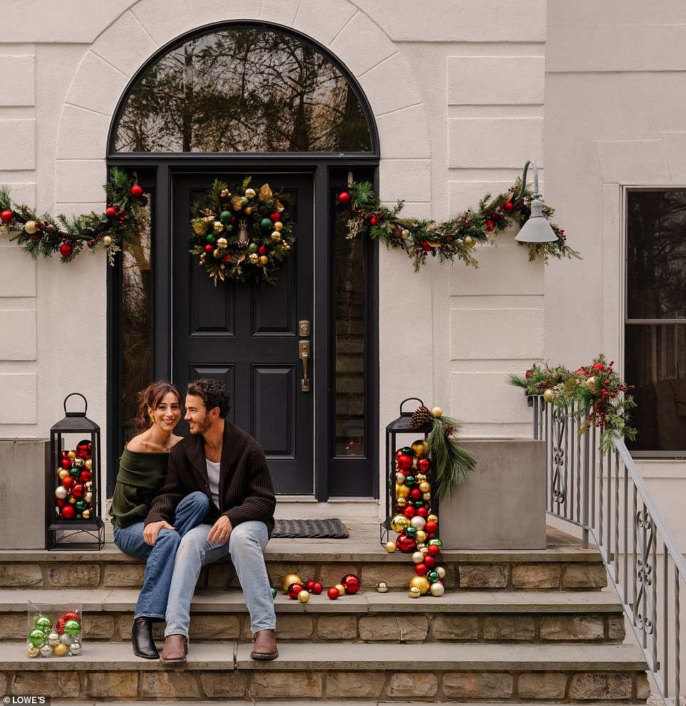 The outside was decorated with multicolored light bulbs and wreaths while they donned blue sweaters and jeans.