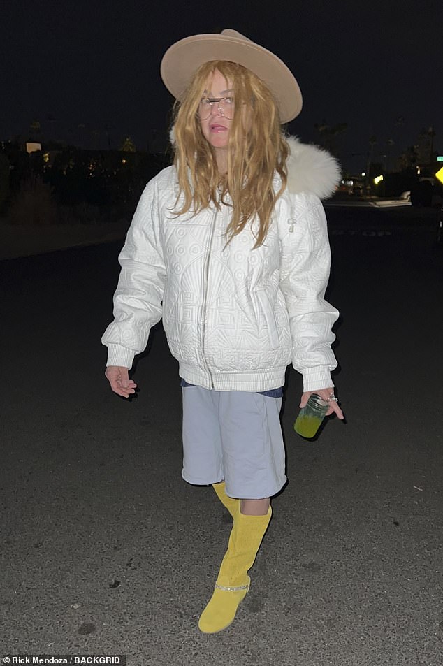 Dressed in a white fur-trimmed jacket, loose-fitting gray shorts, and knee-high yellow suede boots, Taryn embraced her unconventional look with style.