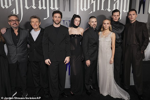 Emma was also joined on the black carpet for a group photo by producer Chris Columbus (L), as well as her black-clad co-stars Bill Skarsgård (2-R) and Nicholas Hoult (R).