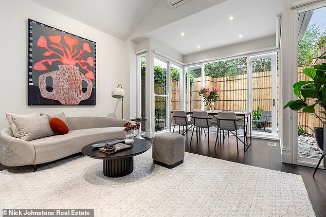 Another standout feature is the modernized kitchen and French doors leading to a private patio.