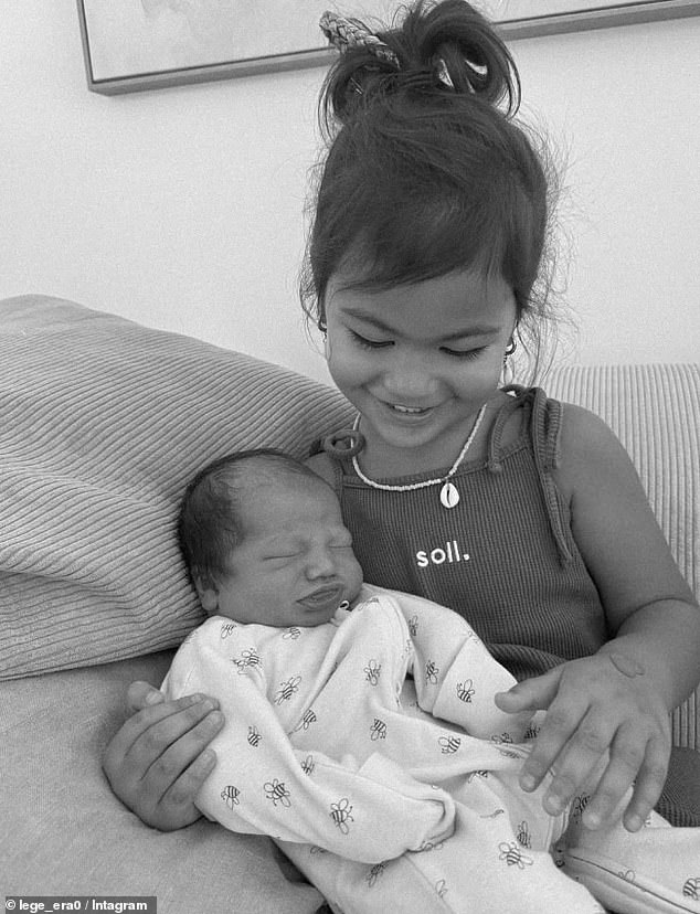 Haas took to Instagram to confirm the news, posting a photo of the newborn cuddled by his older sister Lala, three (pictured).