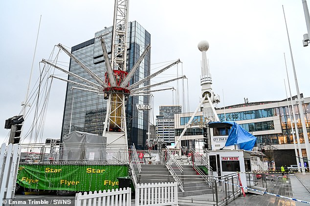 Two people have been taken to hospital after a 180ft fairground ride 'failed and crashed' in Birmingham city center (pictured, the fairground on Friday morning)