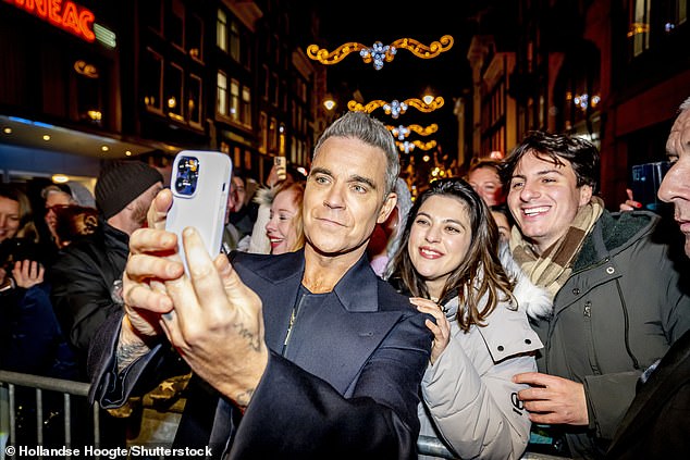 The latest appearance comes just after Robbie couldn't contain his excitement while posing for selfies with fans at the Better Man premiere in the Netherlands on Tuesday night.