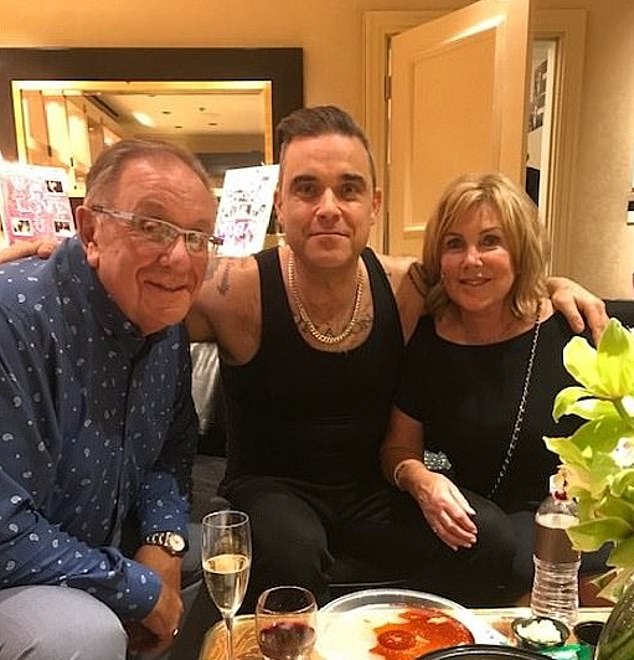 Last month, Robbie revealed his beloved mother Janet's dementia diagnosis, four years after the singer revealed his father Pete had Parkinson's (pictured together in 2019).