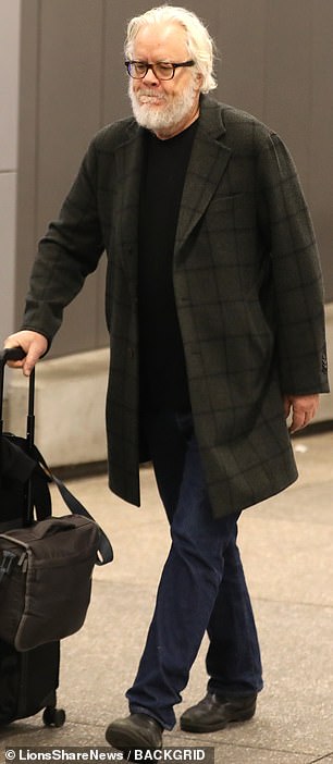 The actor in question is The Shawshank Redemption star Tim Robbins, who was spotted dragging a carry-on bag through Los Angeles International Airport this week.