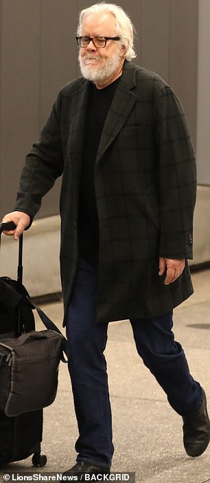 Tim cut a dapper figure during his latest sighting, wearing a moss green plaid coat over a black T-shirt and a set of fashionable dark jeans.