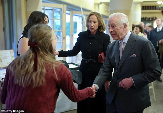 Charles smiled as he shook hands with the students before chatting about the work they did during the year.