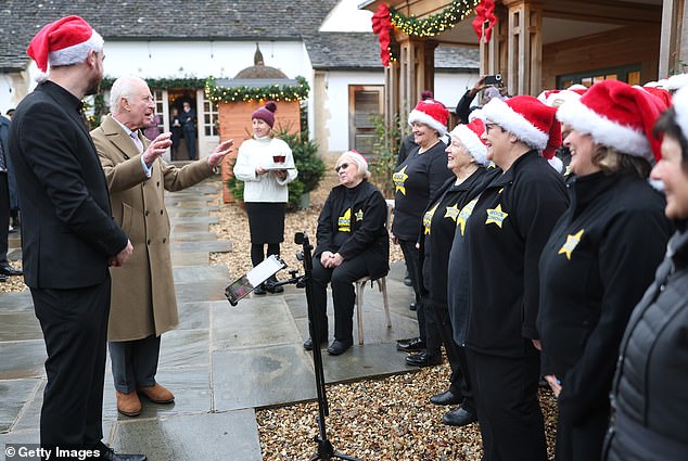 Charles seemed pleased to meet a local rock choir at the event, who donned matching Santa hats.