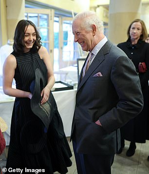 Charles shared a laugh with a student as they talked about their experience in a crafts course.