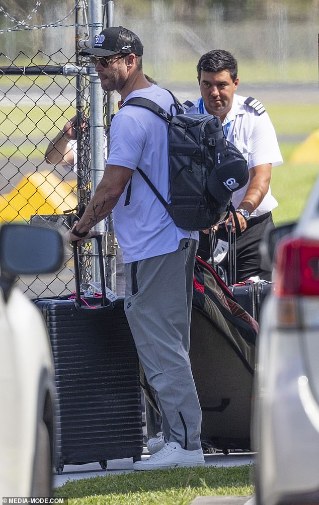 He carried the essentials in a black backpack and was every inch a doting father as he emerged with his son.