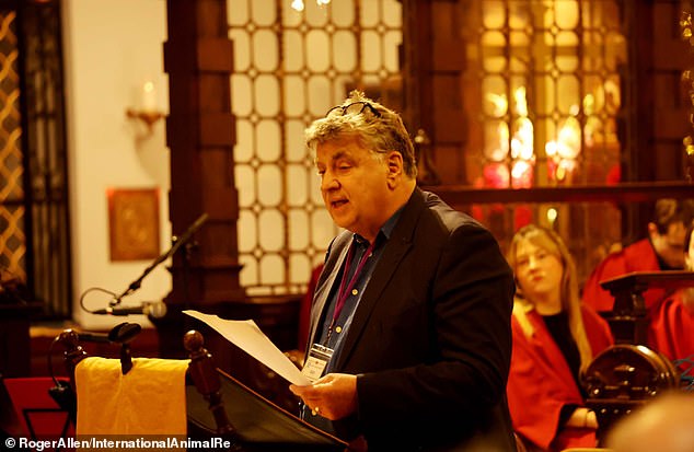 Alan Knight, president of International Animal Rescue, speaks at the carol service