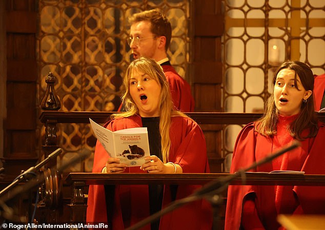 A choir dressed in traditional costumes sings with the congregation.