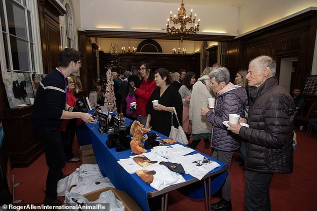 Representatives from International Animal Rescue sell merchandise to raise money for their charity.