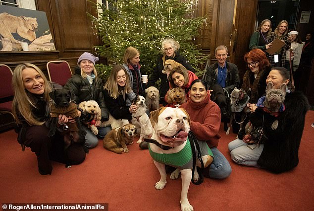 Participants of the howling service pose for the camera with their owners