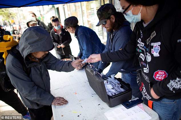 The Drug User Liberation Front distributes clean, tested doses of drugs during a demonstration demanding the legalization and regulation of safe alternatives to the toxic street drug supply in Vancouver, British Columbia, Canada, April 14, 2022