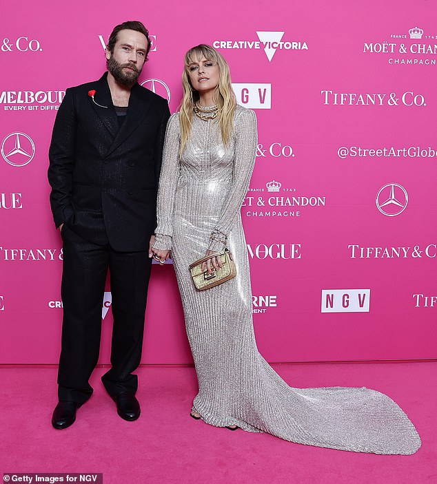 The Lights Out star held hands with her handsome husband Mark Webber, who was dapper in black.