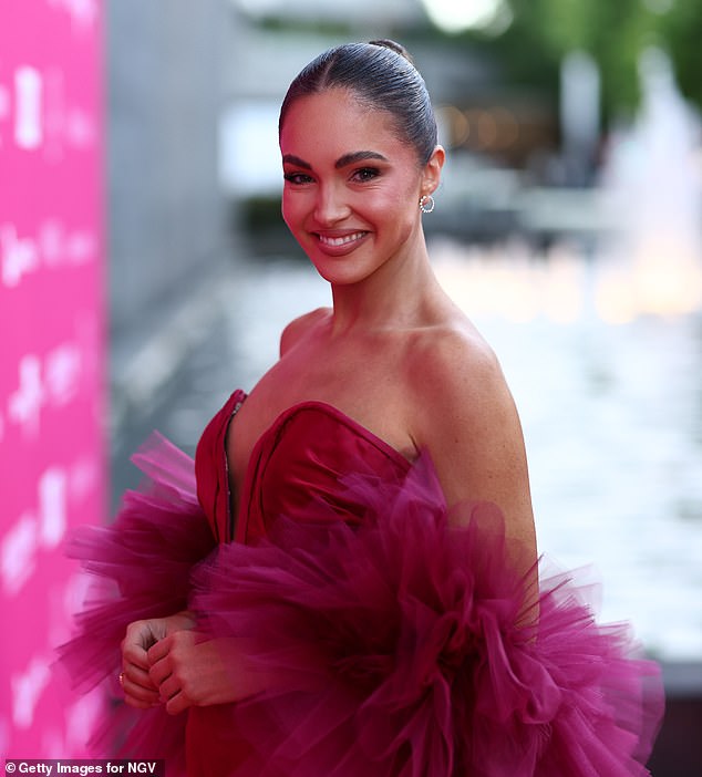 The former Miss Universe Australia showed off her figure in a sleeveless dress with a plunging neckline.