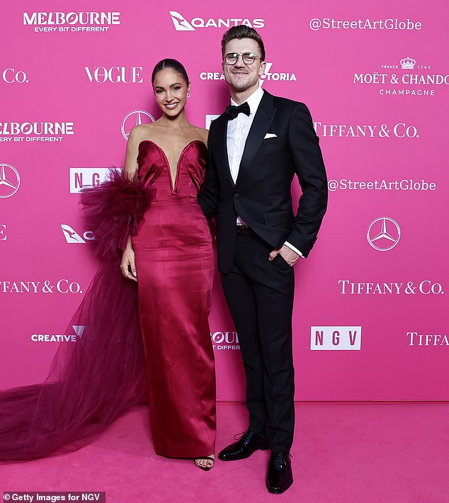 She smiled alongside her new boyfriend, Melbourne businessman Hugo, who looked dapper in a classic tuxedo.