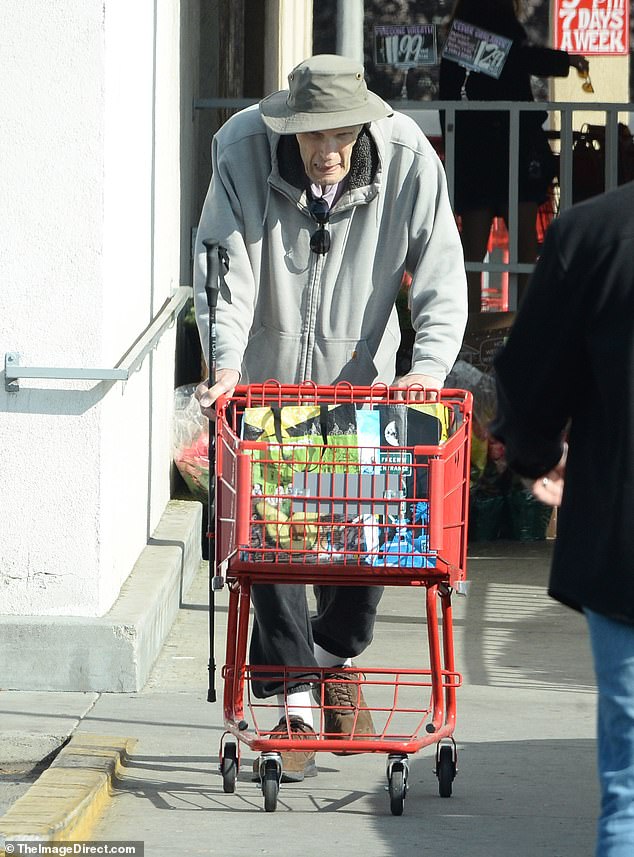 He protected his head with a green bucket hat and wore a pair of dark sunglasses.