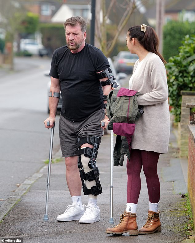 Nick was now seen struggling to walk after having surgery on his left knee and also had pins in his left arm.