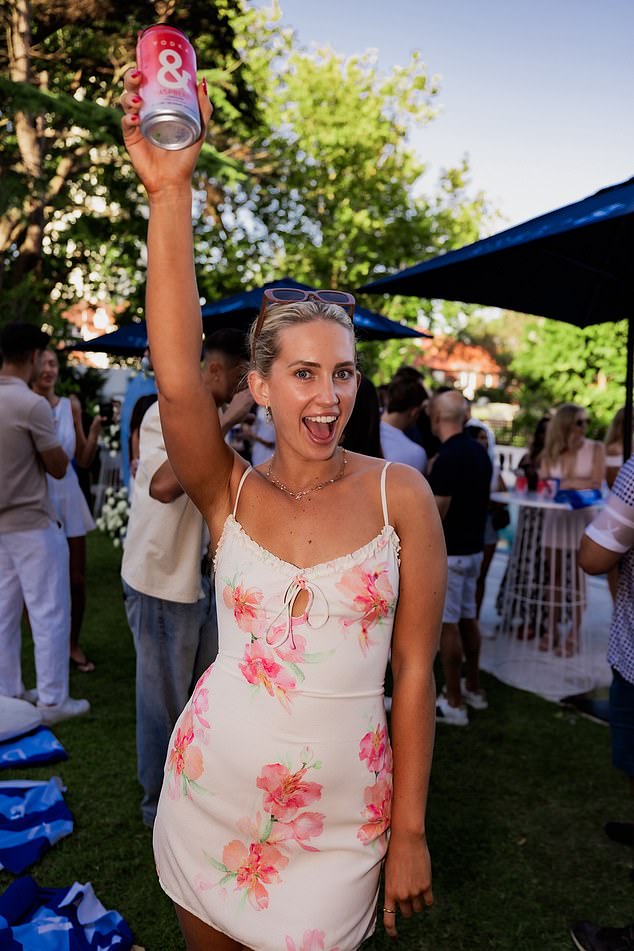 Stella Hutcheon looked radiant in a flirty white minidress adorned with vibrant pink floral prints