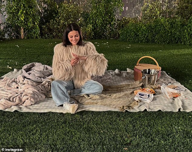 A picnic basket and a Taco Bell box could be seen nearby as the actress looked happily at the ring on her finger.