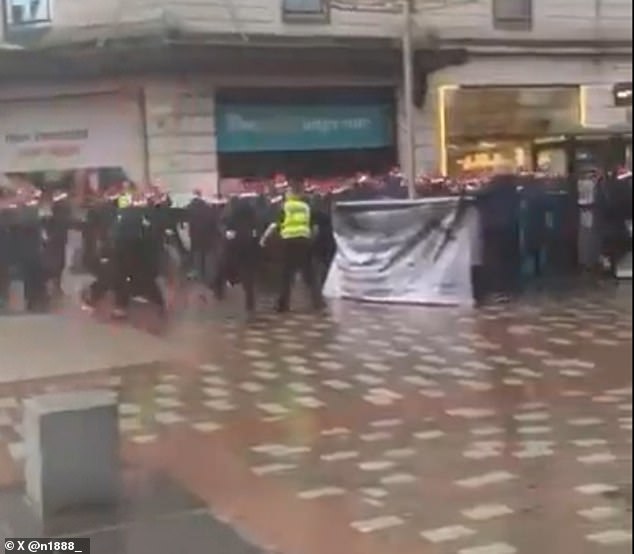 A video posted on social media shows black-clad rioters breaking through a police cordon outside Debenhams on Argyle Street.