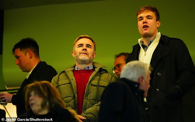 The Take That singer bundled up in a green quilted coat which he layered over a stylish red sweater and a plaid shirt.