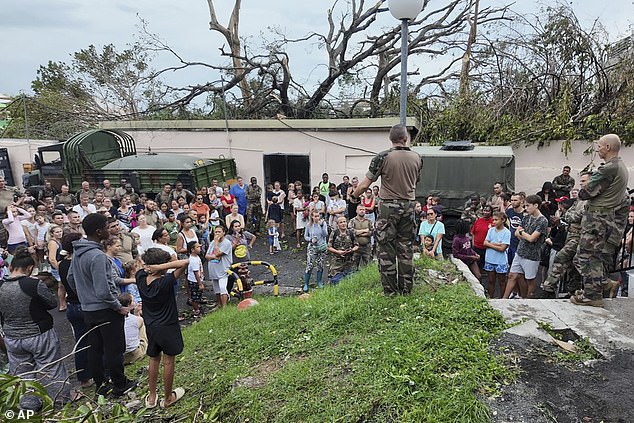 This photo provided on Sunday, December 15, 2024 by the French army shows soldiers addressing the population in the French territory of Mayotte in the Indian Ocean.