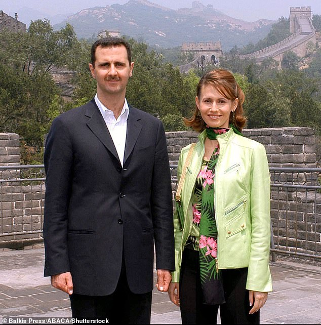 Bashar al-Assad and his wife Asma al-Assad pose during a visit to the Great Wall of China in Badaling on June 22, 2004.