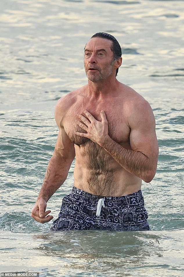 Taking a shirtless dip in the water, Hugh revealed his biceps while swimming after enjoying a gym session with a friend.