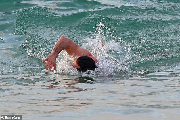 Hugh showed off his rippling abs and arms as he went for a swim.