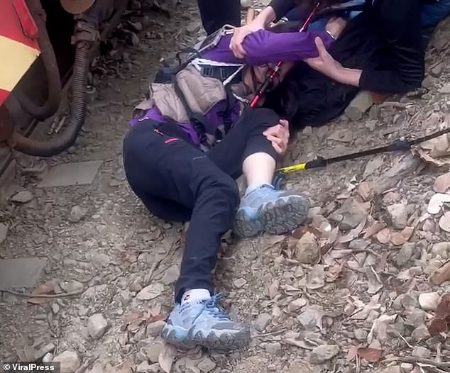 A friend ran to help her after the collision and she can be seen lying on the ground with her head resting on his lap.