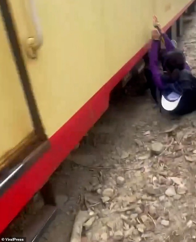 Lui is seen falling under the train, but it is incredible that he escaped alive.