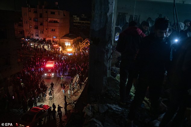 Palestinians inspect the site after an Israeli airstrike hit a UNRWA-run school housing displaced people in Khan Yunis, southern Gaza Strip, December 15, 2024