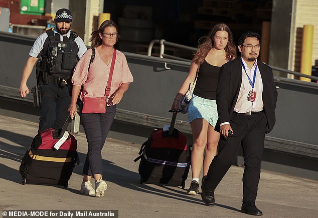 Tanya Sandoe, 56, and her daughter Georgia Sandoe-Simpson, 19, left the terminal through a side exit escorted by Australian Federal Police officers.