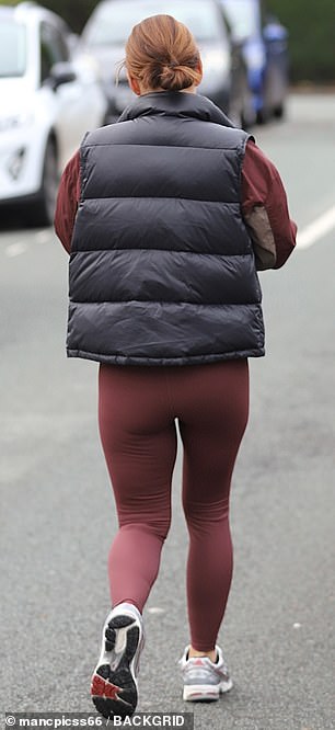 Coleen showed off her amazing physique in plum leggings and a black puffer jacket.